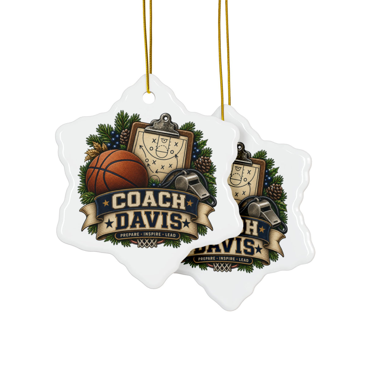 Two white snowflake-shaped Christmas ornaments hanging from gold strings, featuring a custom basketball-themed graphic with the text 'COACH DAVIS' and sports icons like a basketball, clipboard, whistle, pinecones, and evergreen branches.